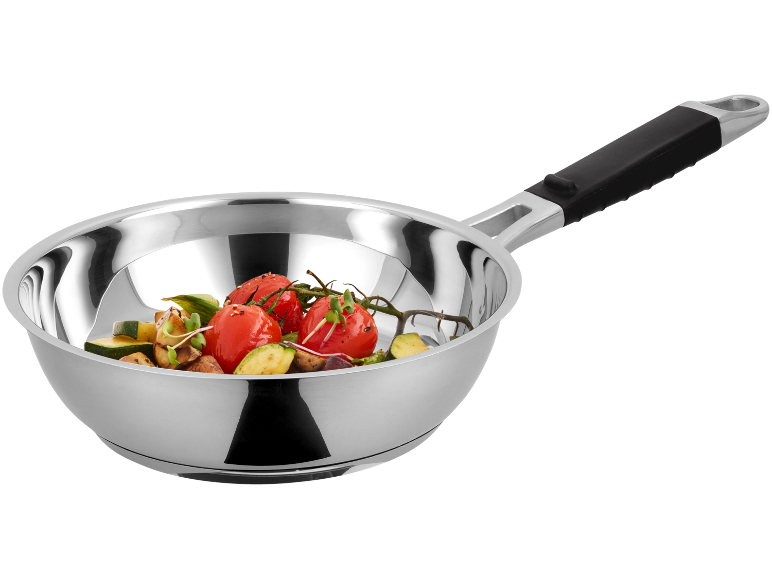 Stainless steel frying pan with roasted vegetables, including tomatoes and zucchini.