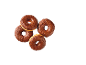 Four chocolate donuts with chocolate sprinkles on a black background.