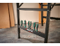 Black workbench with a series of screwdrivers in a holder.