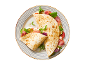 Piadina with ham, mozzarella, tomato, zucchini, and arugula on a striped plate.