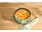 Apple pie in a springform pan on a wooden table with a towel.