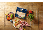 Flatbread with meat, tomato, and lettuce filling, with a package of flatbread.