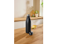 Black thermal bottle and a cup of lemon tea on a wooden kitchen countertop.