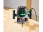 Wood router on a wooden workbench, cutting a groove.
