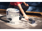 Person cleaning a carpet with a carpet and upholstery cleaner.