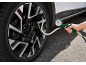 Tire inflator with pressure gauge connected to a car tire valve.