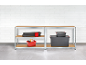 Metal shelving unit with wooden shelves, storing boxes and tools.