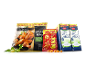 A package of chicken wings, a bag of peanuts, and two cartons of milk.