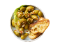 Marinated green olives with chili and garlic, served with toasted bread slices.