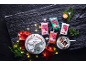 Christmas cakes and colorful fondant packaging on a dark background.