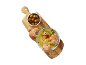 Wooden board with green olives, bread, and a bowl of olive oil with garlic and herbs.