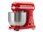 Red stand mixer with a stainless steel bowl and '1973' embossed on top.