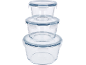 Stack of three round glass food storage containers with blue-rimmed lids