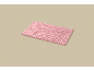 A rectangular pink bath mat on a beige background.