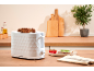 White toaster with toasted bread, served with cheese and tomatoes on a wooden counter.