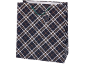 Gift bag with a dark plaid pattern and green handles.