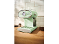 Mint green espresso machine with a temperature gauge and cups on top.