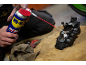 Man applying multi-use lubricant to a motorcycle brake caliper.
