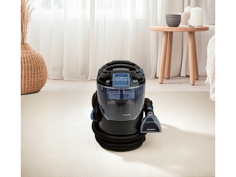 Carpet and upholstery cleaner in a bright living room.
