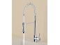 Chrome kitchen faucet with pull-out spray and flexible hose, water flowing into the sink.