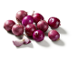 Whole and quartered red onions on a white background.