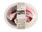 Frozen dessert with berry swirls in a clear plastic container, showing nutritional information.