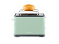 Mint green toaster with a bread roll on the warming rack.