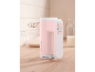 Pink hand mixer on a kitchen counter with whisks and ingredients.