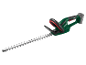 Cordless hedge trimmer with a long blade and black handle on a black background.
