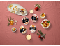 Coffee, hazelnut, peach, vanilla, banana, and caramel ice cream desserts in a Christmas setting.