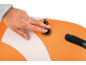 Hand closing air valve of an orange and white inflatable paddle board.