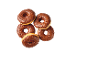 Five chocolate donuts with chocolate sprinkles on a black background.