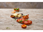 Tapas platter with cheese, olives, serrano ham on bread, and fried peppers.