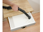 Man cleaning a drawer with a handheld vacuum cleaner
