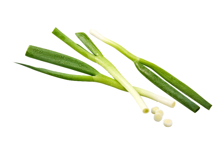 Fresh green onions with water droplets, some sliced, on a black background.