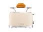 Beige toaster with a bun on the warming rack, featuring the inscription '1973'.