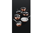 A collection of copper-colored pots and pans with stainless steel interiors and glass lids.