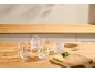 Six glasses with water, lemon, and mint on a wooden kitchen counter.