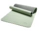 Partially rolled green and grey exercise mat on a black background.