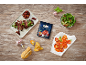 Sun-dried tomatoes in a pouch, served with seared steak, salad, and bread on a wooden table.