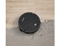Robot vacuum cleaner cleaning a carpet with dirt next to a wooden floor.