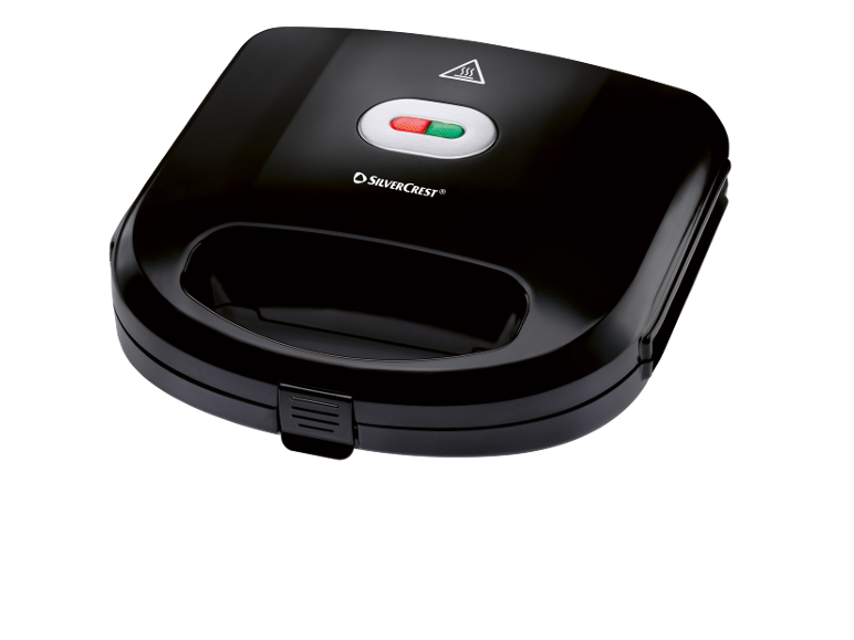 Black sandwich maker with a red and green indicator light and a handle.
