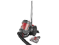 Red and grey bagless vacuum cleaner with hose and brush on a black background.