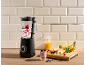 Blender with berries and yogurt, with fresh fruit and juice on the side.