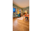 Kids' room with play kitchen, toy food, and a bed with string lights.