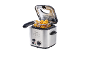 Stainless steel deep fryer with basket full of golden chicken nuggets.