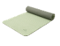 Green exercise mat with one end rolled up, featuring a grid pattern and a logo.