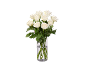 A bouquet of white roses in a glass vase.