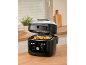 Multifunction air fryer with fries, displaying 180°C and various cooking modes.