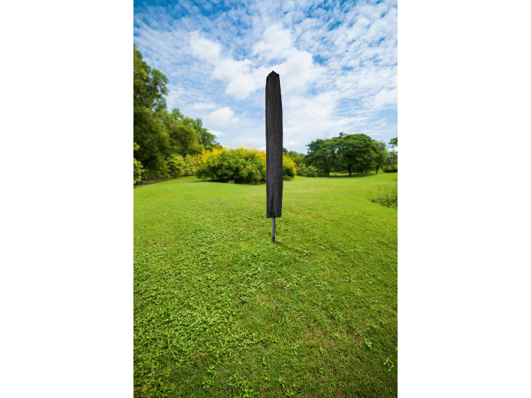 Rotary clothesline with black protective cover in a green garden.